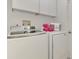 Convenient laundry room with washer, dryer, and cabinets at 5076 Kingsley Rd, North Port, FL 34287