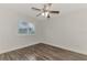 Well-lit bedroom with wood-look floors and window shutters at 5076 Kingsley Rd, North Port, FL 34287
