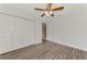Spacious bedroom with wood-look floors and built-in closet at 5076 Kingsley Rd, North Port, FL 34287