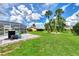 Large backyard with lush green grass and palm trees at 5076 Kingsley Rd, North Port, FL 34287