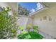 Private patio with artificial turf and seating at 338 Pembroke Dr # 208, Venice, FL 34293