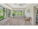 Sunroom with garden views and wicker furniture at 338 Pembroke Dr # 208, Venice, FL 34293
