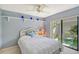 Guest bedroom with patio access and white bedding at 338 Pembroke Dr # 208, Venice, FL 34293