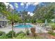 Community pool with lounge chairs and lush landscaping at 338 Pembroke Dr # 208, Venice, FL 34293
