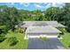 Three-unit building with individual garages and lush landscaping at 338 Pembroke Dr # 208, Venice, FL 34293