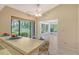 Kitchen features light wood cabinets, breakfast bar, and view to sunroom at 338 Pembroke Dr # 208, Venice, FL 34293