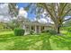 Charming single-story home with a large oak tree and manicured lawn at 338 Pembroke Dr # 208, Venice, FL 34293