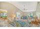 Spacious living room with vaulted ceilings, a ceiling fan, and wicker furniture at 338 Pembroke Dr # 208, Venice, FL 34293