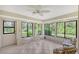 Sunroom with multiple windows, offering a tranquil garden view at 338 Pembroke Dr # 208, Venice, FL 34293