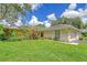 Tan house with a two-car garage and lush green lawn at 338 Pembroke Dr # 208, Venice, FL 34293