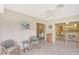 Bright sunroom with wicker furniture and view of kitchen at 338 Pembroke Dr # 208, Venice, FL 34293
