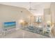 Living area with vaulted ceiling, featuring a flat-screen TV and tropical decor at 338 Pembroke Dr # 208, Venice, FL 34293