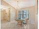 Spacious dining area with glass table and chairs near entryway at 338 Pembroke Dr # 208, Venice, FL 34293