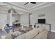 Bright and airy living room featuring comfortable seating and a large TV at 12760 Brookgreen St, Venice, FL 34293
