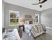 Serene bedroom with a comfortable bed, workspace, and large windows at 12760 Brookgreen St, Venice, FL 34293
