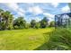 Large backyard with lush grass and tropical landscaping at 12760 Brookgreen St, Venice, FL 34293