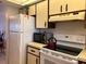Bright kitchen features white appliances and ample cabinetry at 929 Capri Isles Blvd # 22, Venice, FL 34292