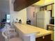 Kitchen boasts a breakfast bar and ample counter space at 929 Capri Isles Blvd # 22, Venice, FL 34292