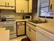 Clean and functional kitchen with white appliances and corner sink at 929 Capri Isles Blvd # 22, Venice, FL 34292