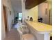 Kitchen with breakfast bar and view into living area at 929 Capri Isles Blvd # 22, Venice, FL 34292