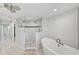 Bathroom with walk-in shower, soaking tub, and white tile at 412 Cezanne Dr, Osprey, FL 34229