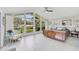 Main bedroom with large windows, tile floors, and mid-century furniture at 412 Cezanne Dr, Osprey, FL 34229