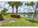 Landscaped backyard with lake view and lush greenery at 13870 Lido St, Venice, FL 34293