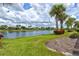 Serene lakefront view with lush landscaping at 13870 Lido St, Venice, FL 34293