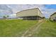 Spacious horse barns with ample stalls and covered areas at 27000 Harrison Rd, Sidell, FL 34266
