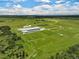 Aerial view of expansive equestrian property with large barn and paddocks at 27000 Harrison Rd, Sidell, FL 34266