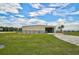 Metal workshop building with double doors and fenced area at 27000 Harrison Rd, Sidell, FL 34266