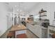 Modern kitchen with white cabinets, island, and a farmhouse sink at 27000 Harrison Rd, Sidell, FL 34266