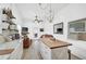 Open kitchen with butcher block island, white cabinets, and stainless steel appliances at 27000 Harrison Rd, Sidell, FL 34266