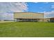 Elevated barn with covered stalls; green grassy field at 27000 Harrison Rd, Sidell, FL 34266
