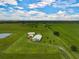 Aerial view of a rural property featuring a home and large acreage at 27000 Harrison Rd, Sidell, FL 34266