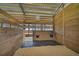 Spacious horse stall with wood paneling and a sand floor at 27000 Harrison Rd, Sidell, FL 34266
