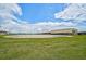 Expansive riding arena surrounded by lush green fields at 27000 Harrison Rd, Sidell, FL 34266