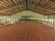 Indoor riding arena with sand footing and stalls at 27000 Harrison Rd, Sidell, FL 34266