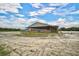 Large covered equestrian barn with multiple stalls at 27000 Harrison Rd, Sidell, FL 34266