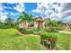 Single-story house with terracotta roof, palm trees, and well-maintained landscaping at 12261 Canavese Ln, Venice, FL 34293