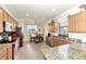 Open kitchen boasting granite countertops, stainless steel appliances, and an island at 12261 Canavese Ln, Venice, FL 34293