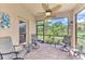 Enjoy this cozy screened porch with ceiling fan and outdoor seating at 12261 Canavese Ln, Venice, FL 34293