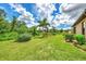 Landscaped backyard featuring lush greenery and vibrant flowers at 12261 Canavese Ln, Venice, FL 34293