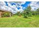 Spacious backyard with lush lawn, beautiful landscaping, and fountain at 12261 Canavese Ln, Venice, FL 34293