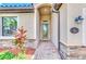 Front entry with glass door, stone accents, and a welcoming walkway at 12261 Canavese Ln, Venice, FL 34293