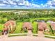 Aerial view of three homes with brick pavers and lush landscaping in a quiet cul-de-sac at 12261 Canavese Ln, Venice, FL 34293