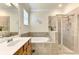 Bathroom with double vanity, garden tub, and walk-in shower at 12261 Canavese Ln, Venice, FL 34293