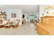 Bright living room featuring comfortable rocking chairs and a view to the kitchen at 12261 Canavese Ln, Venice, FL 34293