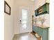 Quaint entryway with green cabinet, decorative items, and a glass door at 12261 Canavese Ln, Venice, FL 34293