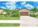 Single-story house with terracotta roof, landscaping, and a brick paver driveway at 12261 Canavese Ln, Venice, FL 34293